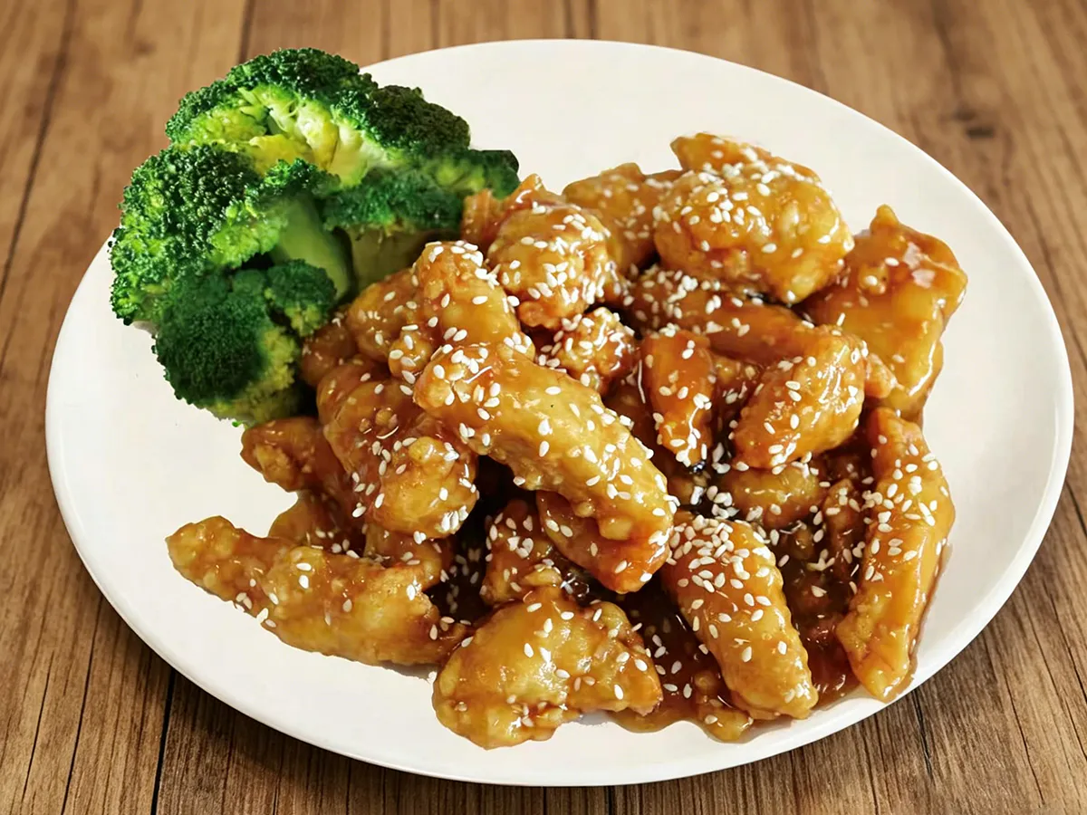 Sesame chicken glazed with sweet sauce served with fresh broccoli at Hau Po Chinese Kitchen, a Chinese Restaurant in Hauppauge